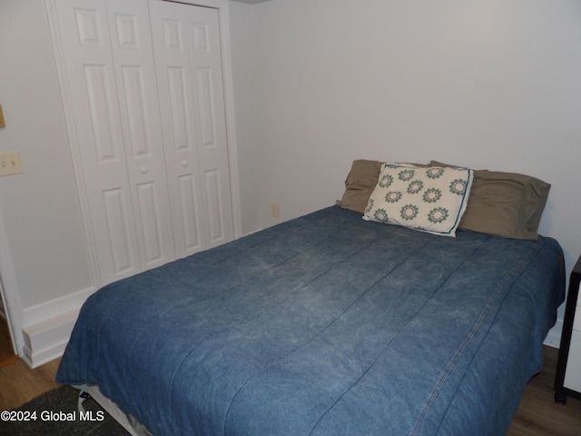 bedroom featuring a closet and dark hardwood / wood-style floors