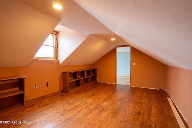 bonus room featuring vaulted ceiling and hardwood / wood-style floors