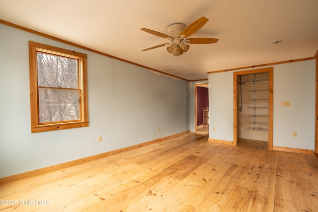 unfurnished bedroom featuring light wood-type flooring and crown molding