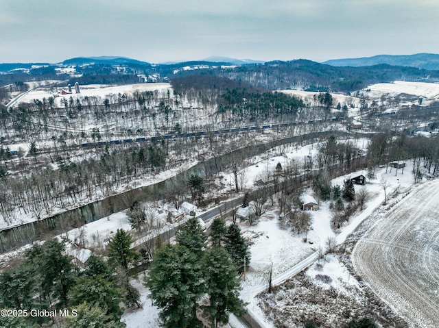 snowy aerial view with a mountain view