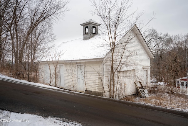 snow covered property with a garage