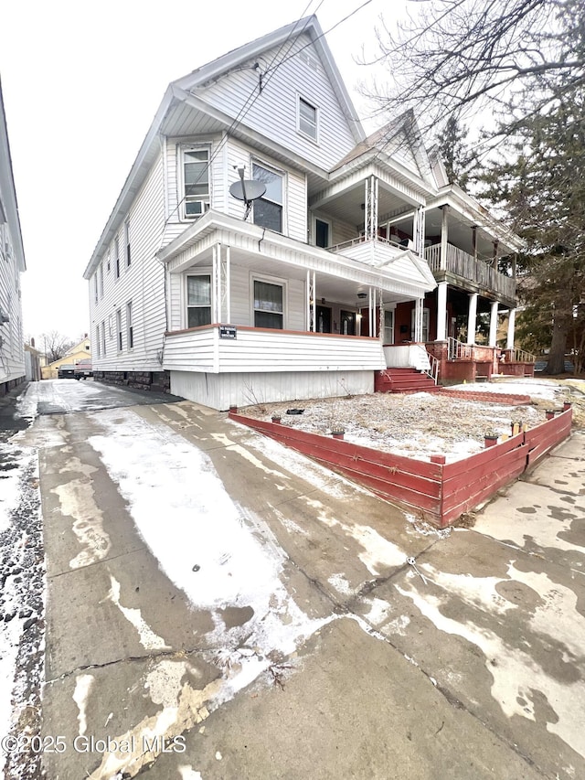 view of front of house with a balcony and covered porch