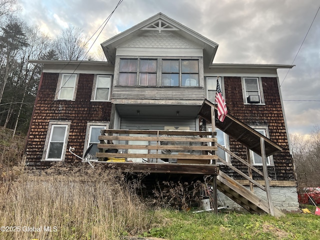 back of house featuring a wooden deck