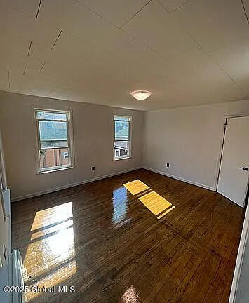 spare room featuring dark hardwood / wood-style floors