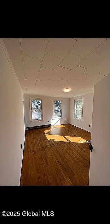 empty room with wood-type flooring