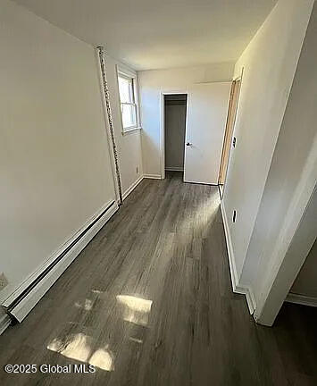 interior space featuring dark hardwood / wood-style flooring and a baseboard radiator