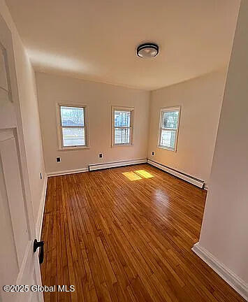 spare room with hardwood / wood-style flooring