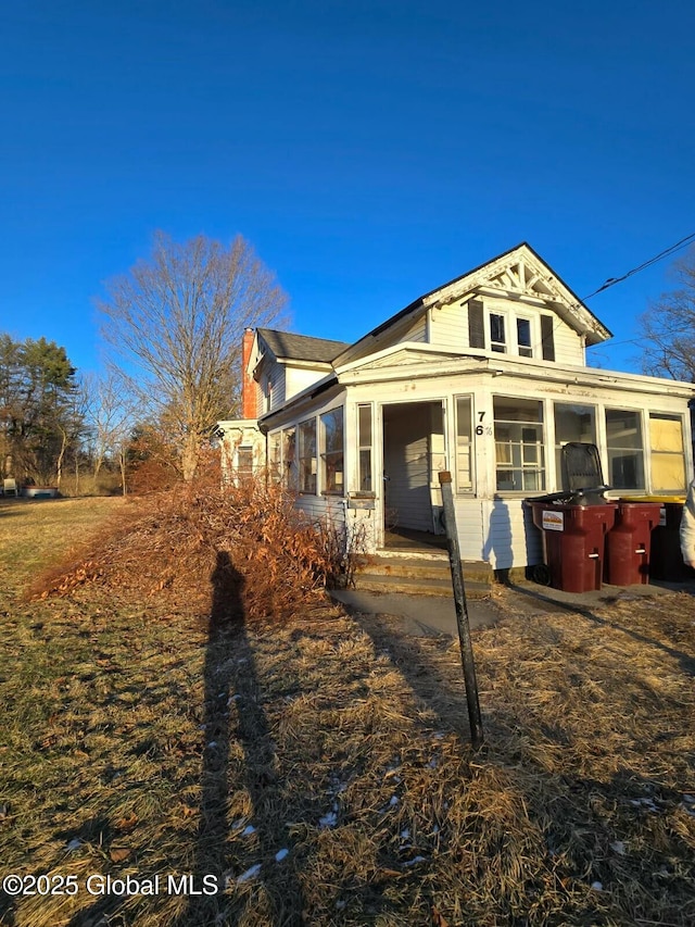 view of home's exterior with a sunroom