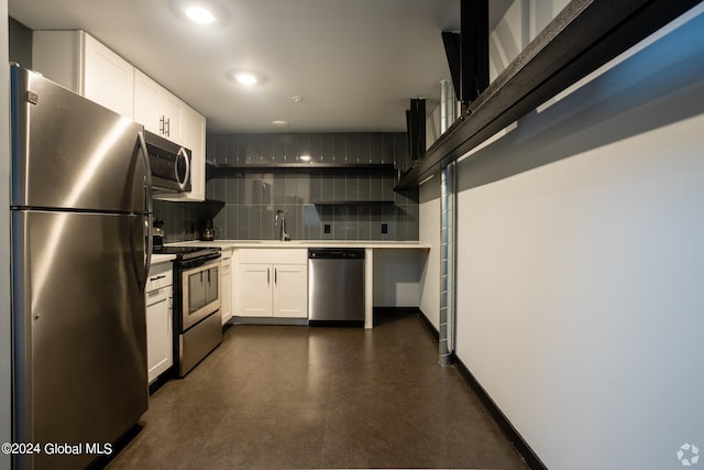 kitchen featuring white cabinets, stainless steel appliances, decorative backsplash, and sink