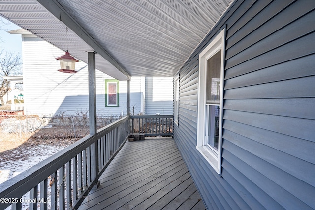 wooden terrace featuring covered porch