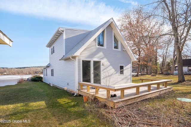 rear view of property with a wooden deck and a yard