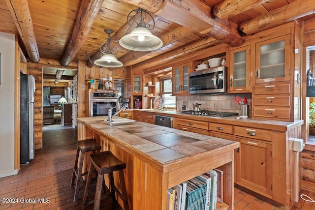 kitchen featuring wooden ceiling, stainless steel appliances, sink, pendant lighting, and beamed ceiling