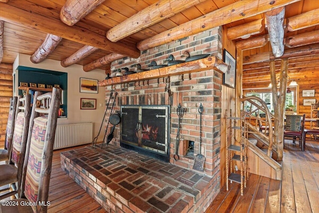 living room with a brick fireplace, hardwood / wood-style floors, beamed ceiling, wood ceiling, and radiator heating unit