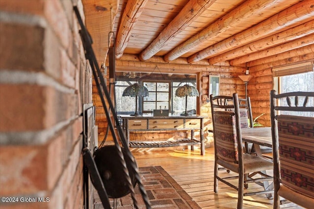 interior space featuring rustic walls, hardwood / wood-style floors, wooden ceiling, and beam ceiling