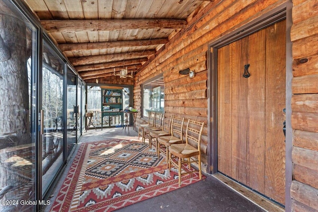 unfurnished sunroom featuring wood ceiling and lofted ceiling with beams