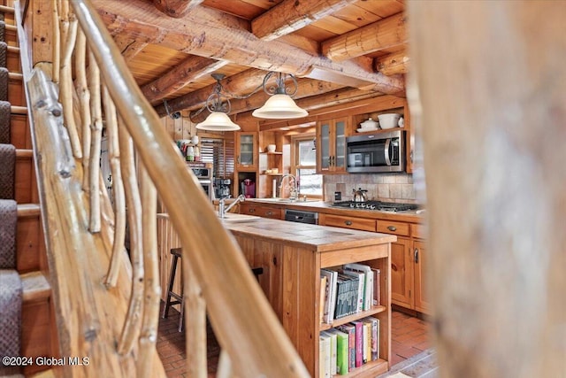 kitchen with wood ceiling, appliances with stainless steel finishes, backsplash, pendant lighting, and sink