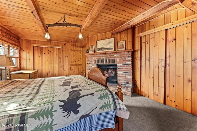 carpeted bedroom with a brick fireplace, wood ceiling, beam ceiling, and wood walls