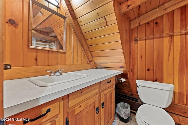 bathroom featuring wood ceiling, tile patterned floors, vanity, wooden walls, and toilet