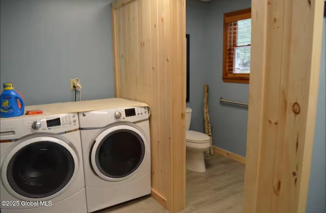 washroom with light wood-type flooring and washer and dryer