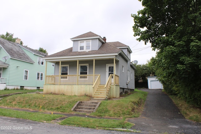 bungalow-style house with an outdoor structure, a porch, and a garage