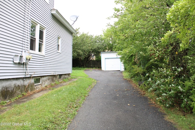 view of side of home with an outdoor structure and a garage