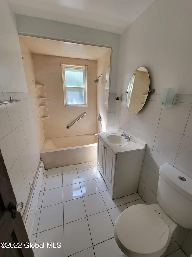 full bathroom with tile patterned floors, vanity, shower / bath combination, tile walls, and toilet