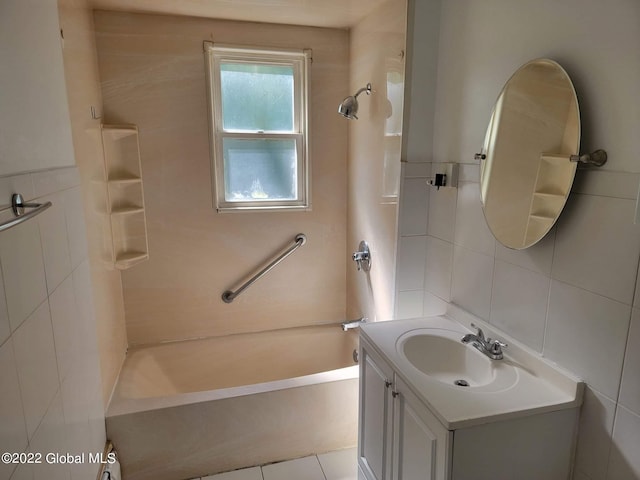 bathroom featuring tile patterned floors, tile walls, shower / tub combination, and vanity