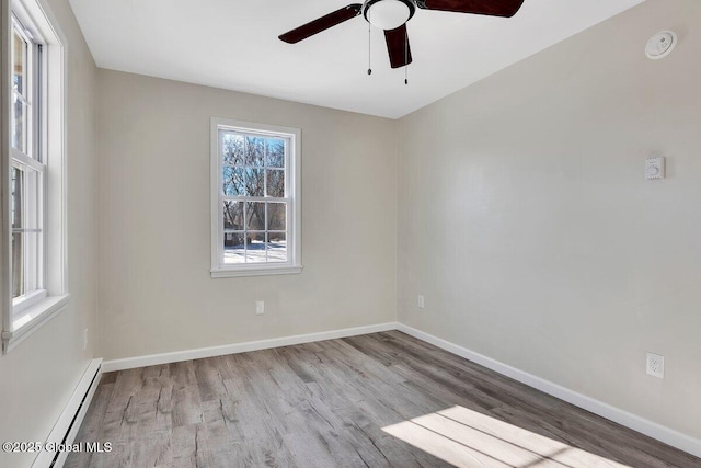 unfurnished room with ceiling fan, a baseboard radiator, and light hardwood / wood-style flooring