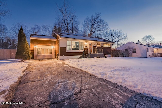 view of front of house featuring covered porch and solar panels