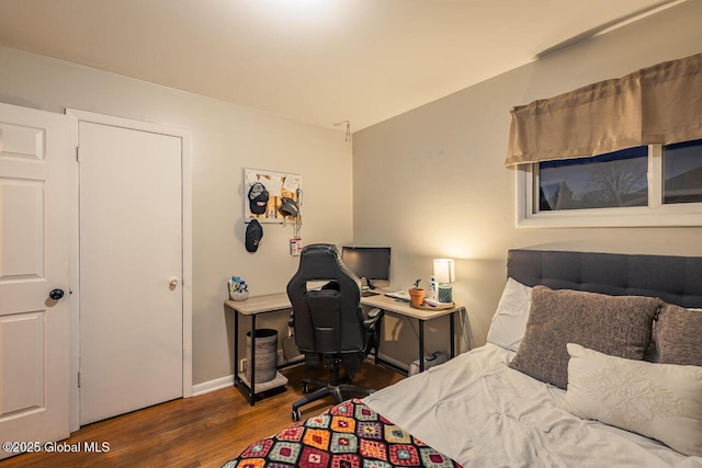 bedroom with dark hardwood / wood-style flooring