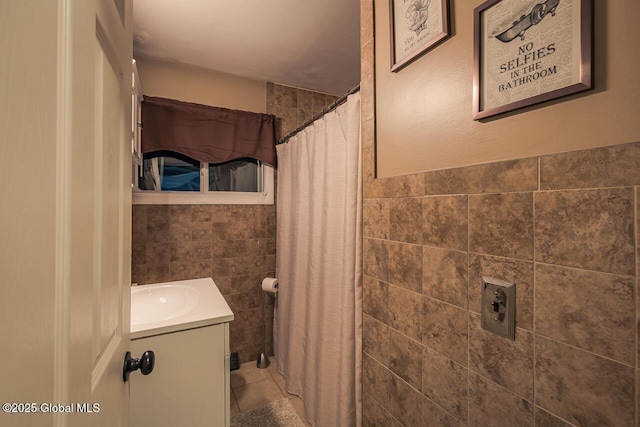 bathroom featuring vanity, tile walls, tile patterned floors, and a shower with shower curtain