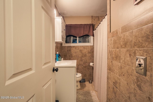 bathroom featuring tile walls, vanity, toilet, tile patterned floors, and a shower with curtain