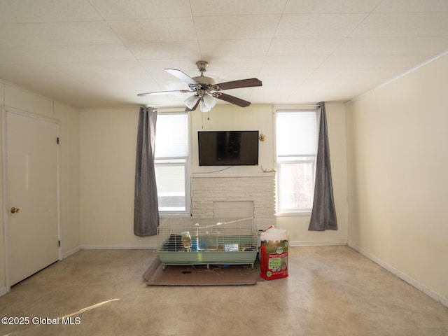 unfurnished living room with a fireplace and ceiling fan