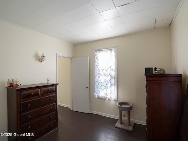 foyer entrance with ornamental molding and dark hardwood / wood-style floors