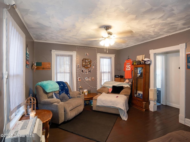 living room with crown molding, ceiling fan, and dark hardwood / wood-style flooring