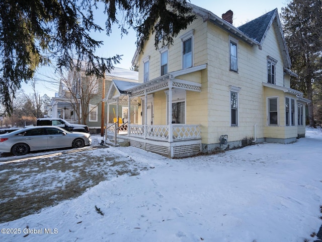 view of snow covered exterior with a porch