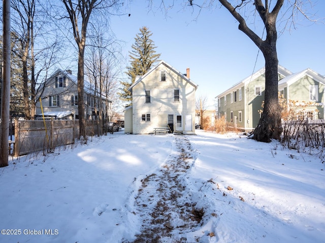 view of snow covered rear of property