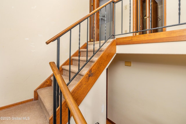 stairs with baseboards and carpet floors