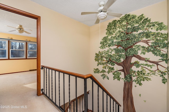 stairs with baseboards, carpet floors, a textured ceiling, and ceiling fan