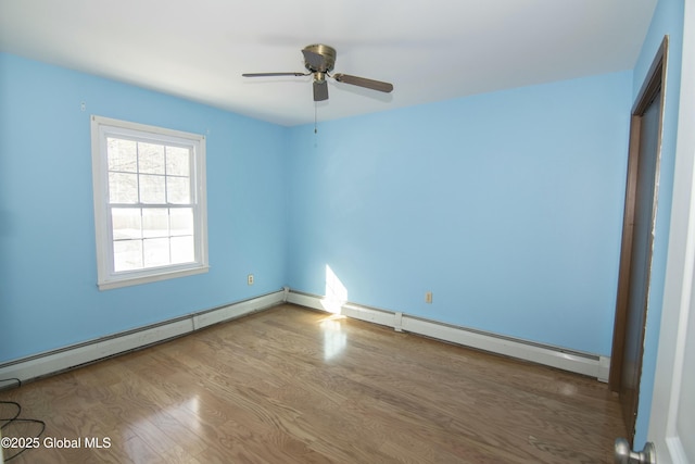 unfurnished bedroom featuring baseboard heating and wood-type flooring