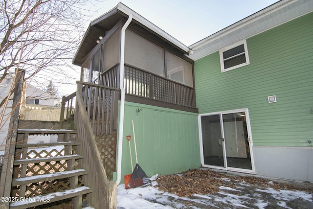 view of snow covered rear of property