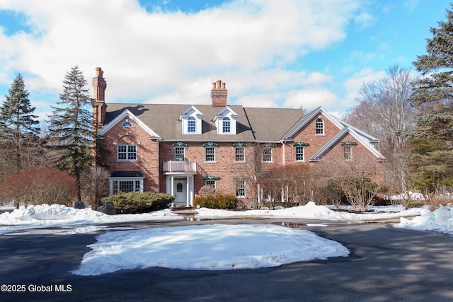 colonial inspired home featuring brick siding