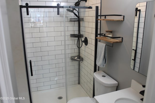 bathroom featuring an enclosed shower, vanity, and toilet