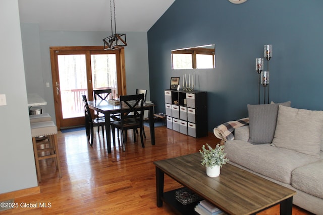 living room featuring hardwood / wood-style floors and vaulted ceiling