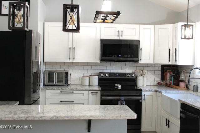 kitchen featuring hanging light fixtures, white cabinets, and black appliances