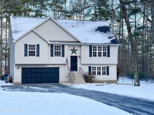 bi-level home with driveway and a garage