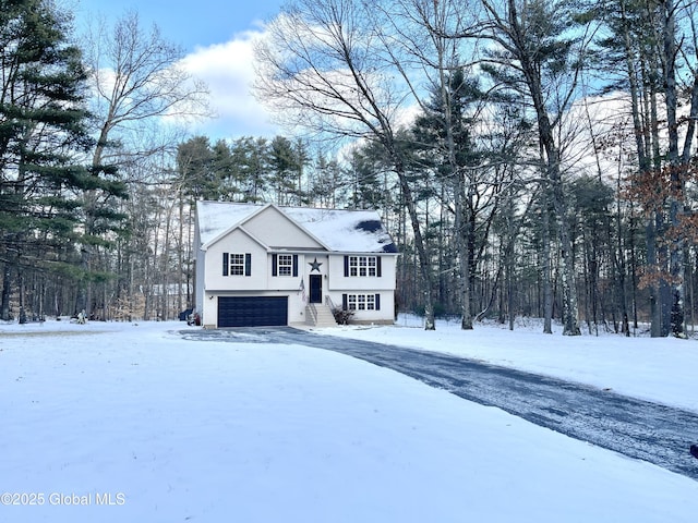 bi-level home featuring a garage and driveway