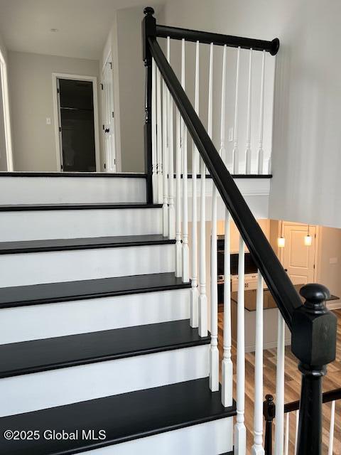 staircase featuring hardwood / wood-style flooring