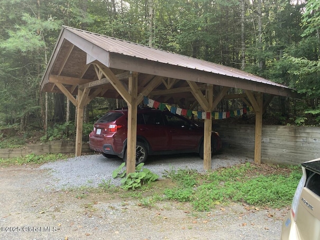 view of car parking with a view of trees and a carport