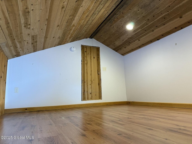 additional living space with wood ceiling, vaulted ceiling, baseboards, and wood finished floors